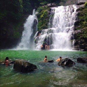 Group bathing in a waterfall