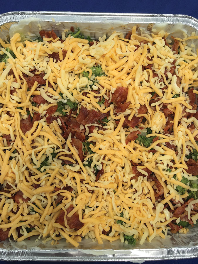 Place in greased baking pan & top with cheese and bacon. 