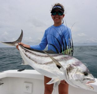 Woman holding a roosterfish