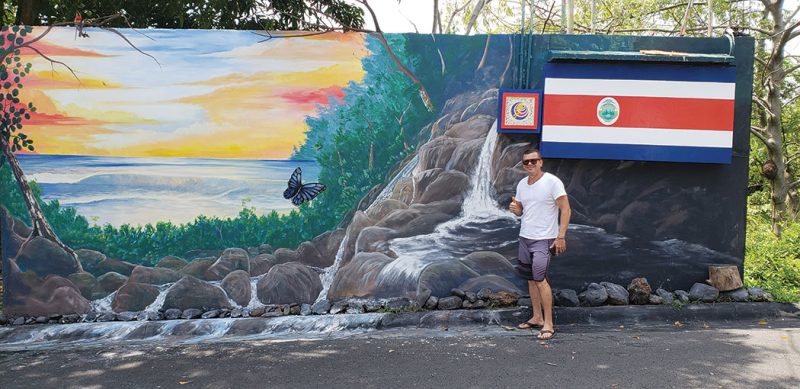 Artist Juan with the mural