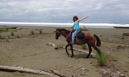 Nancy riding a horse on the beach