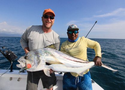 Two men holding large roosterfish
