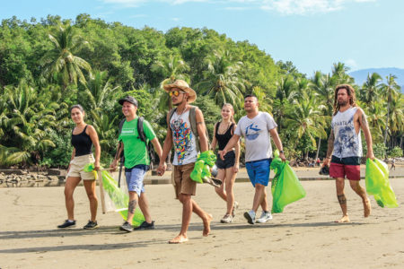 Group collecting trash on the beach