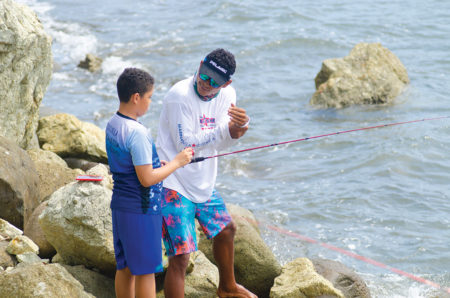Instructor a boy fishing