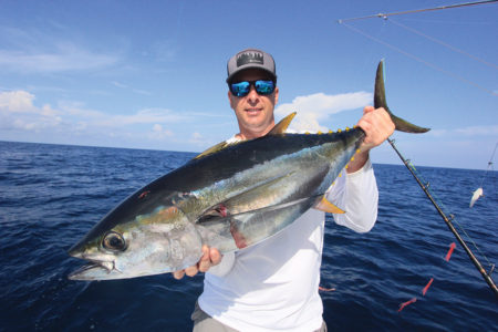 Man holding a tuna.