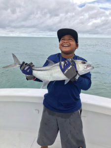 Boy holding a large fish