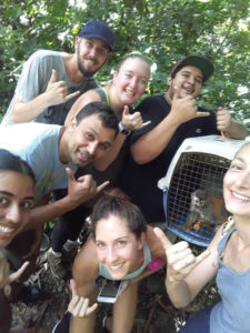 Volunteers with a titi monkey