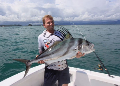 man holding a roosterfish