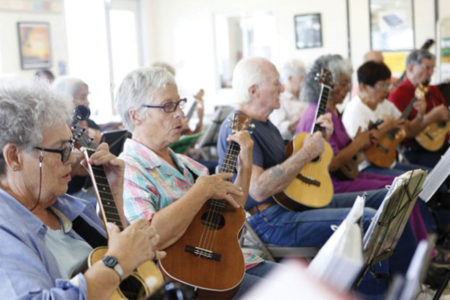 Seniors learning to play ukuleles