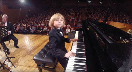 Boy playing piano concert