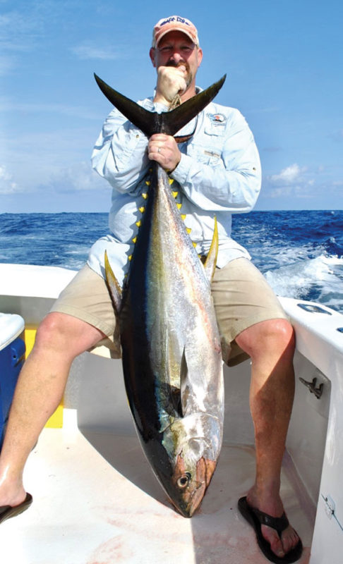 Man holding a tuna