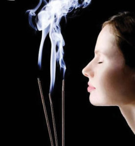 woman inhaling incense